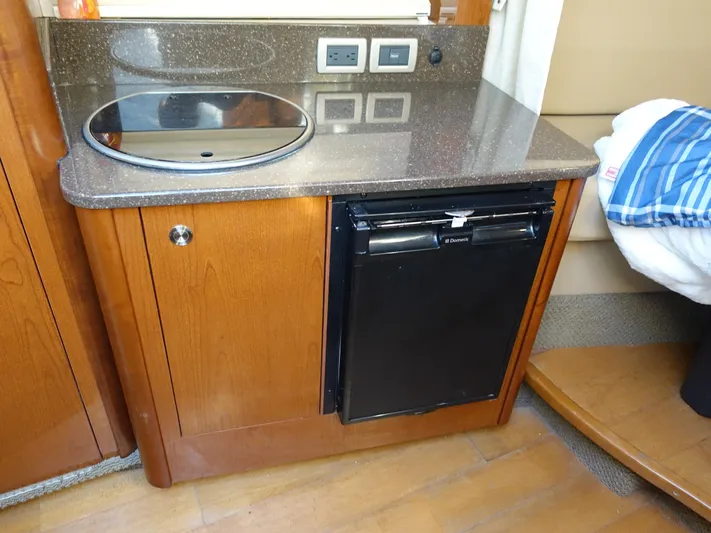  Yacht Photos Pics Compact kitchenette in 2013 Sea Ray 370 Venture with sink and mini fridge.