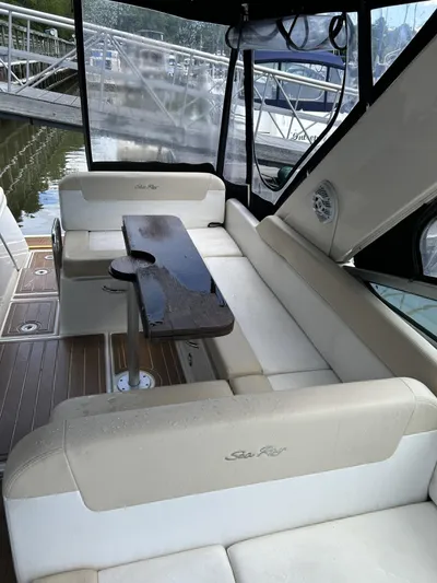  Yacht Photos Pics 2013 Sea Ray 370 Venture boat interior with cushioned seating and wooden table.