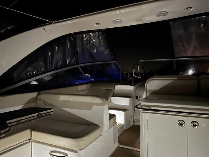  Yacht Photos Pics Interior of 2013 Sea Ray 370 Venture yacht at night, featuring seating and cabinetry.