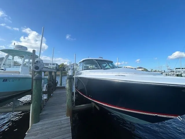  Yacht Photos Pics 2017 Pursuit DC 325 Dual Console boat docked under a clear blue sky.