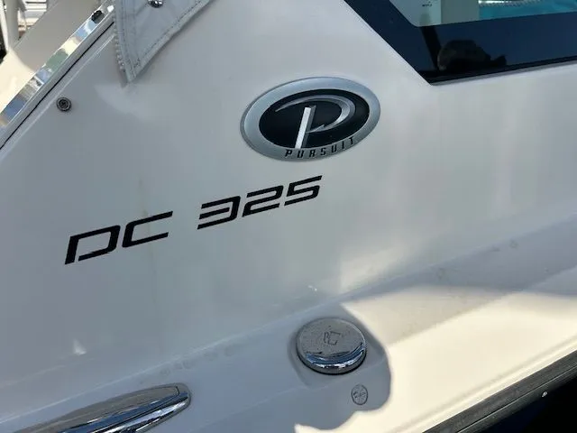  Yacht Photos Pics 2017 Pursuit DC 325 Dual Console boat, close-up of model name and logo.