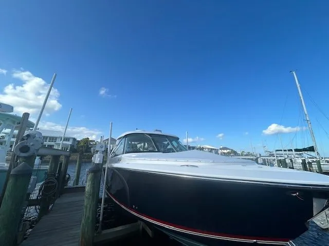  Yacht Photos Pics 2017 Pursuit DC 325 Dual Console boat docked under clear blue sky.