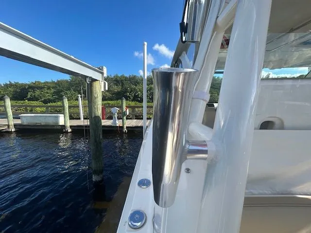  Yacht Photos Pics 2017 Pursuit DC 325 Dual Console boat docked by a marina under clear blue sky.