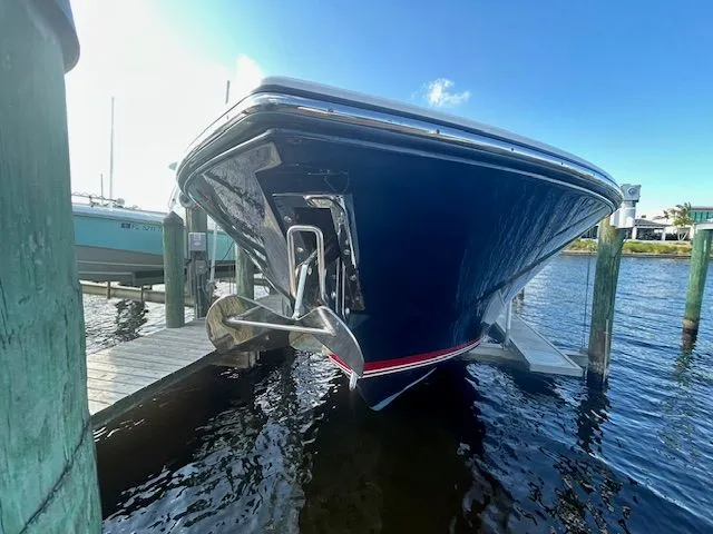  Yacht Photos Pics 2017 Pursuit DC 325 Dual Console boat docked, showcasing sleek hull design and anchor.