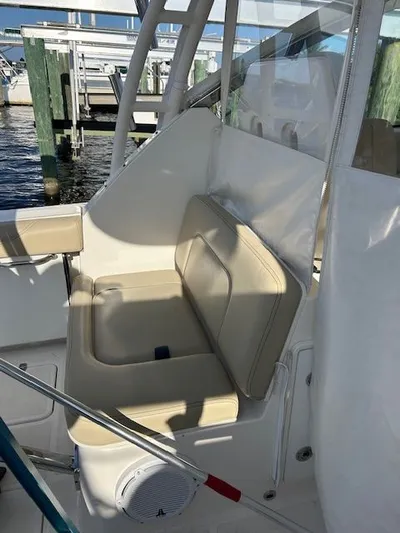  Yacht Photos Pics 2017 Pursuit DC 325 Dual Console boat interior with beige seating and marina background.