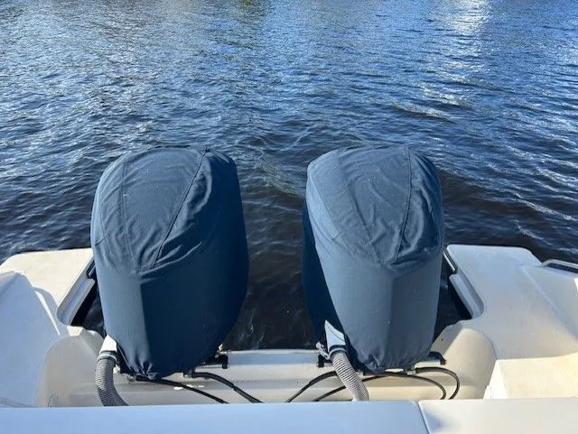  Yacht Photos Pics 2017 Pursuit DC 325 Dual Console boat engines covered, docked on calm water.