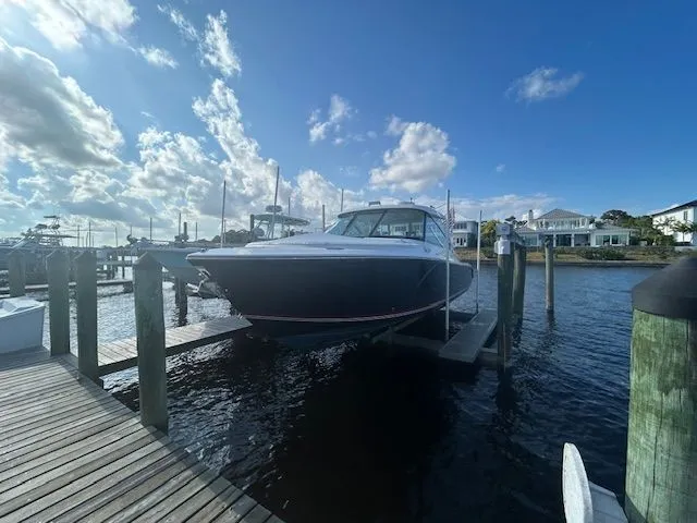  Yacht Photos Pics 2017 Pursuit DC 325 Dual Console boat docked under a bright blue sky.