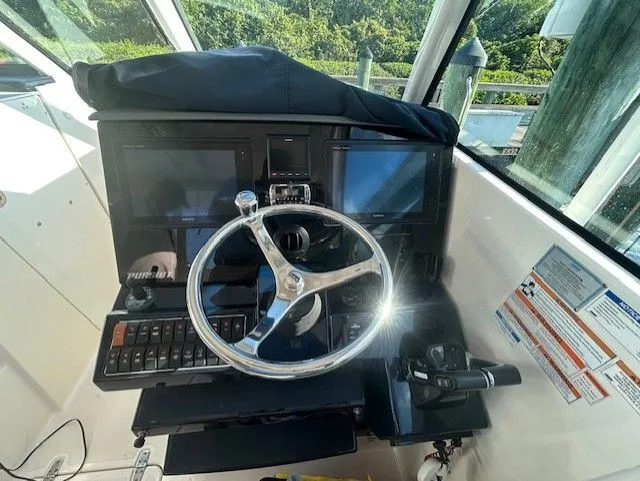  Yacht Photos Pics 2017 Pursuit DC 325 Dual Console helm with steering wheel and control panel.