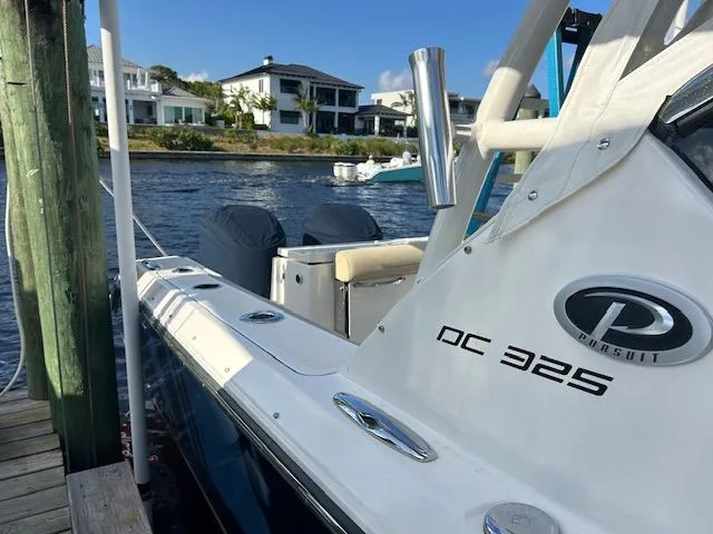  Yacht Photos Pics 2017 Pursuit DC 325 Dual Console boat docked by waterfront homes.
