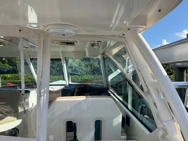  Yacht Photos Pics 2017 Pursuit DC 325 Dual Console boat interior with clear windows and seating.