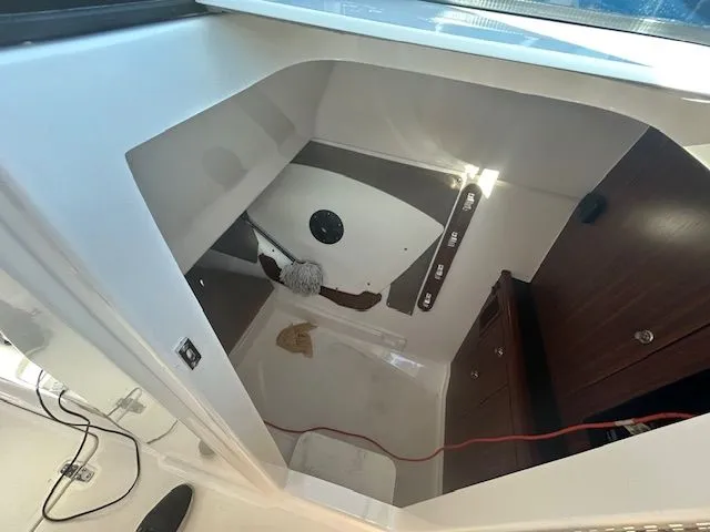  Yacht Photos Pics 2017 Pursuit DC 325 Dual Console interior cabin with storage and cleaning supplies.