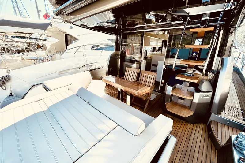  Yacht Photos Pics Luxurious 2020 Cranchi E 52F Evoluzione yacht interior with seating and wooden stairs.