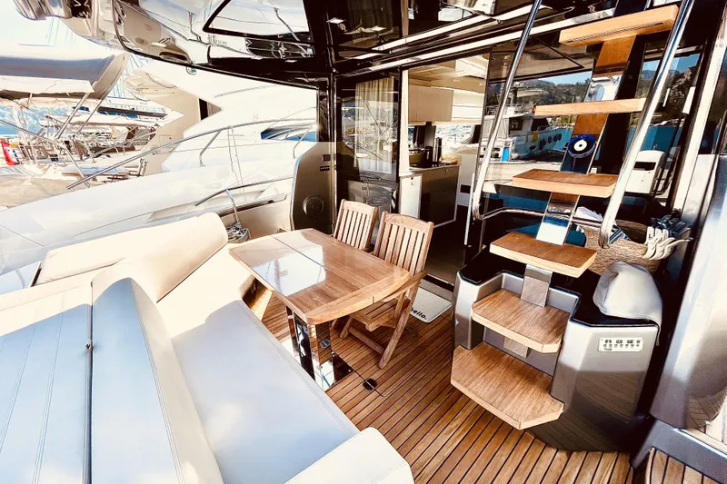  Yacht Photos Pics Luxurious 2020 Cranchi E 52F Evoluzione yacht interior with wooden dining area and modern staircase.