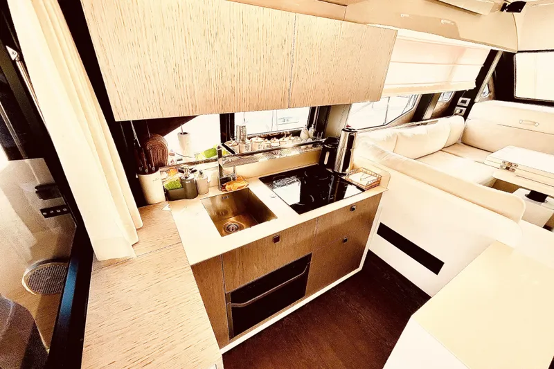  Yacht Photos Pics Luxurious 2020 Cranchi E 52F Evoluzione yacht interior with modern kitchen and seating area.