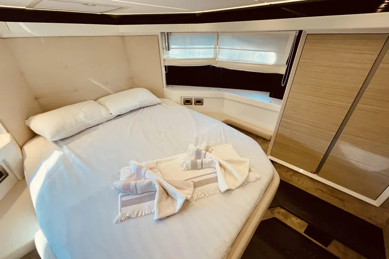  Yacht Photos Pics Luxurious bedroom interior of 2020 Cranchi E 52F Evoluzione yacht with elegant bedding.