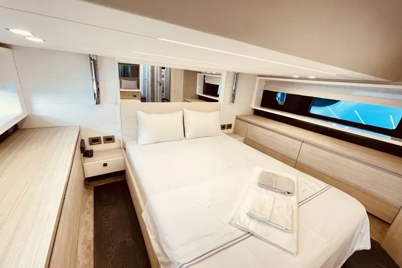  Yacht Photos Pics Luxurious bedroom interior of 2020 Cranchi E 52F Evoluzione yacht, featuring modern design.