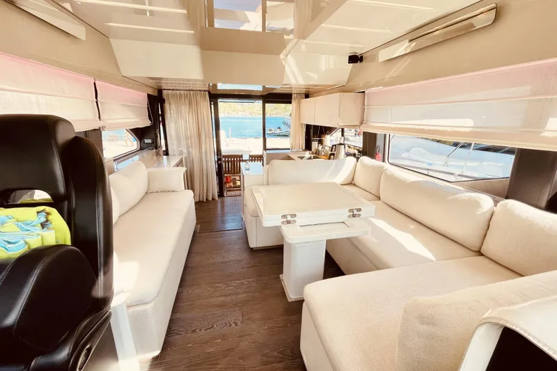  Yacht Photos Pics Luxurious interior of 2020 Cranchi E 52F Evoluzione yacht with elegant seating and table.