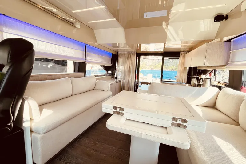  Yacht Photos Pics Luxurious interior of 2020 Cranchi E 52F Evoluzione yacht with elegant seating and dining area.
