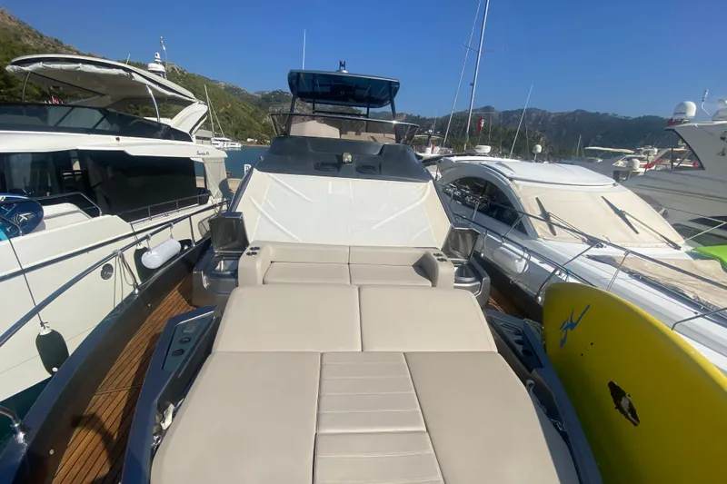  Yacht Photos Pics 2020 Cranchi E 52F Evoluzione yacht with sunbathing area, docked among other boats.