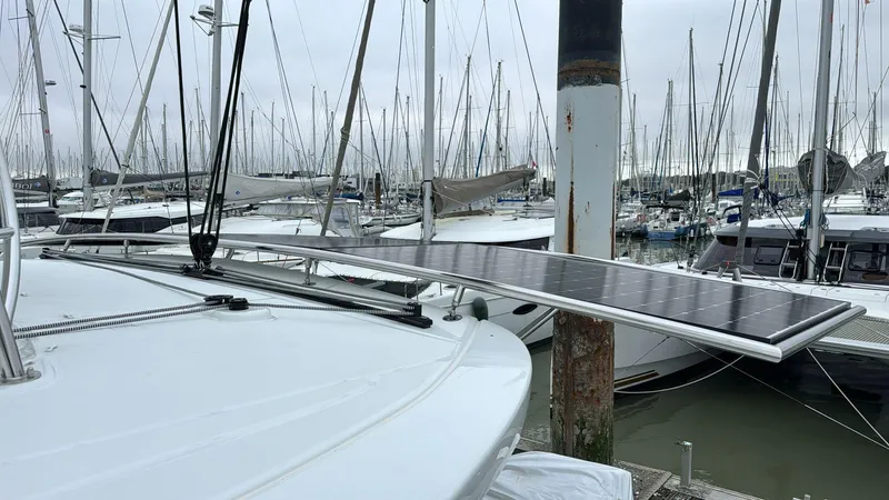  Yacht Photos Pics 2025 Lagoon 46 catamaran with solar panel in marina.