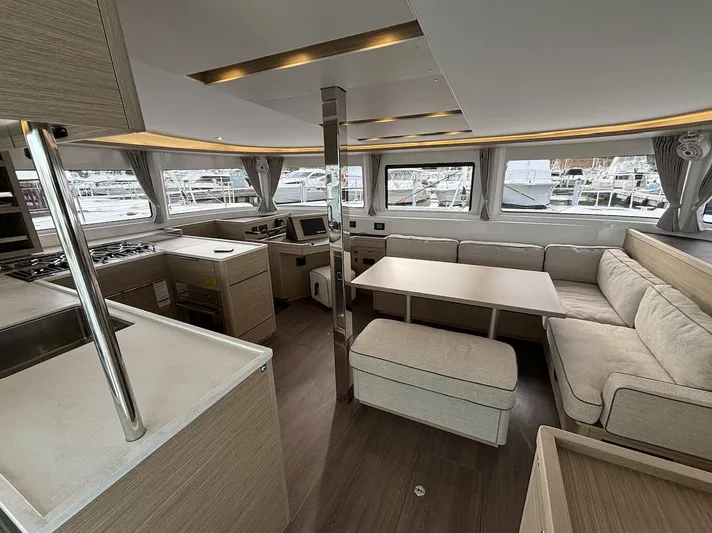  Yacht Photos Pics Luxurious interior of 2025 Lagoon 46 catamaran with modern kitchen and seating area.