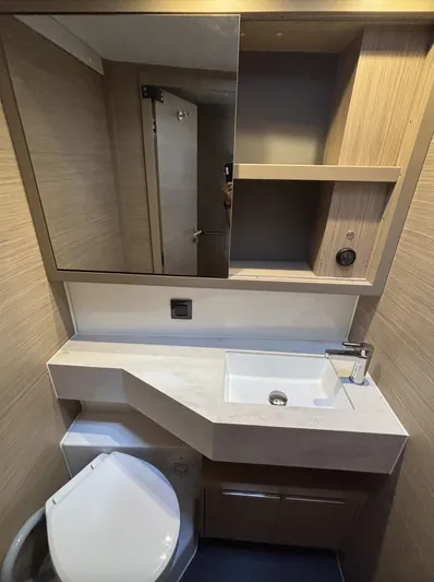  Yacht Photos Pics Modern bathroom in 2025 Lagoon 46 yacht with sleek sink and storage.