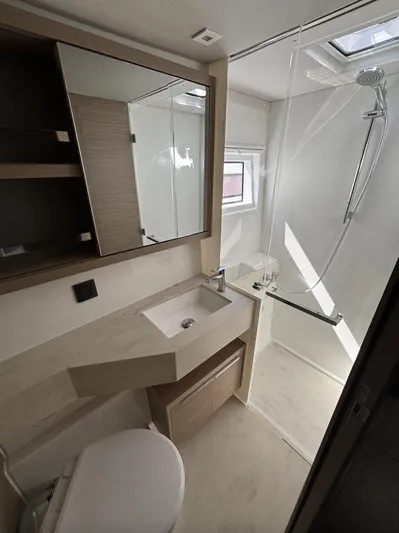  Yacht Photos Pics Modern bathroom in 2025 Lagoon 46 yacht with shower and sleek fixtures.