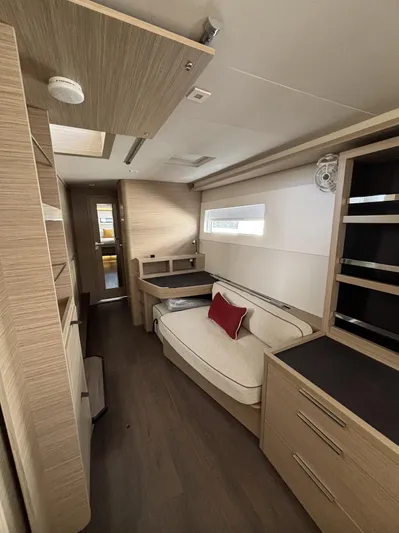  Yacht Photos Pics Interior of 2025 Lagoon 46 yacht with modern wood finish and cozy seating area.