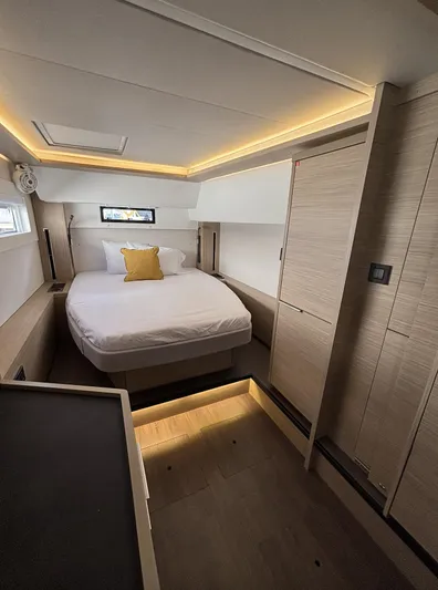  Yacht Photos Pics Luxurious cabin interior of 2025 Lagoon 46 yacht with modern lighting and cozy bed.