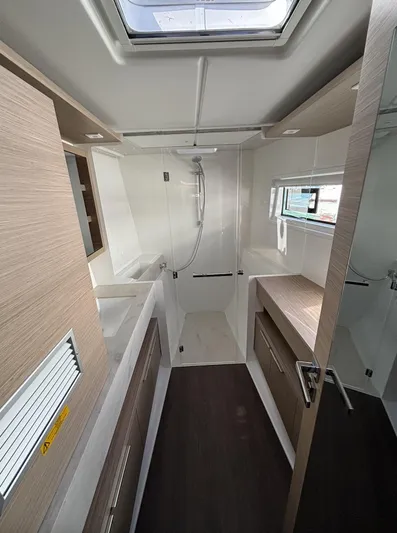  Yacht Photos Pics Modern bathroom in 2025 Lagoon 46 yacht with sleek design and natural lighting.