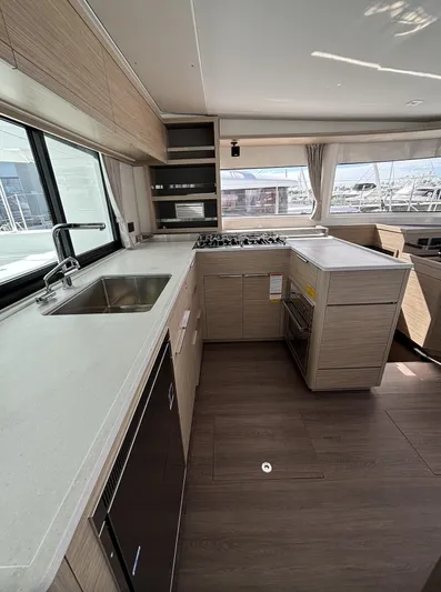  Yacht Photos Pics Modern kitchen interior of 2025 Lagoon 46 catamaran with sleek countertops and appliances.