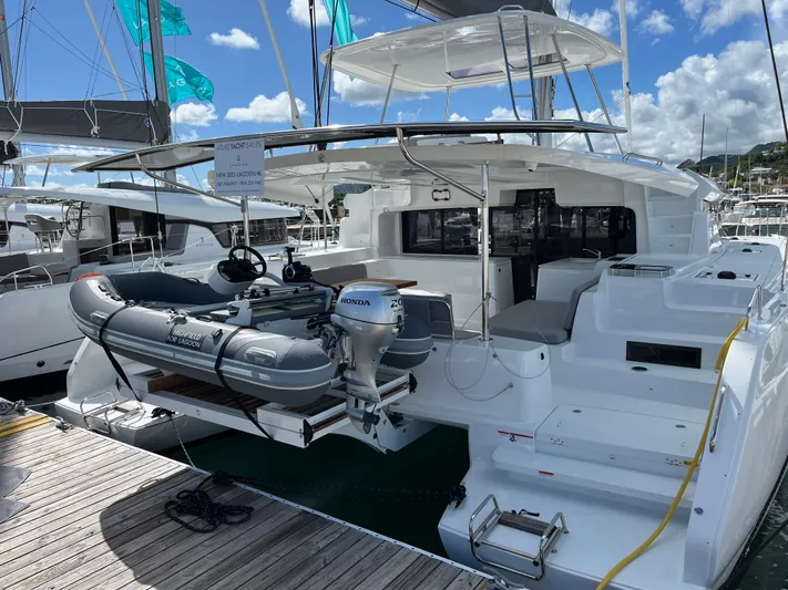  Yacht Photos Pics 2025 Lagoon 46 catamaran docked with inflatable boat and Honda motor.