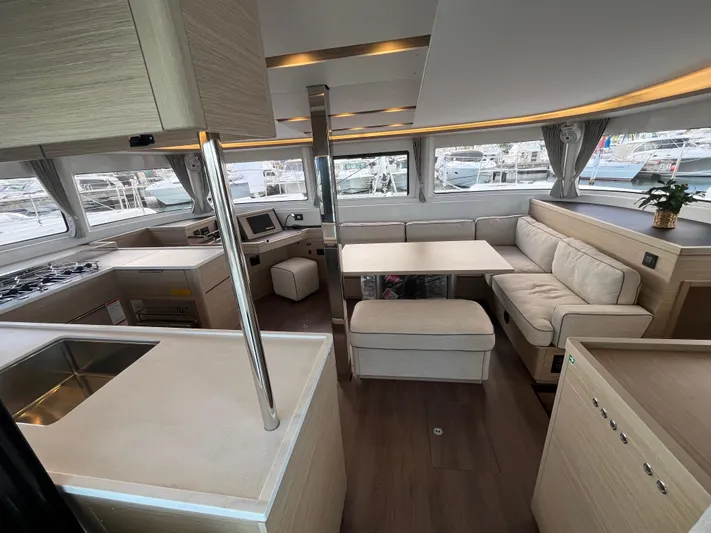  Yacht Photos Pics Luxurious interior of 2025 Lagoon 46 catamaran with modern kitchen and seating area.