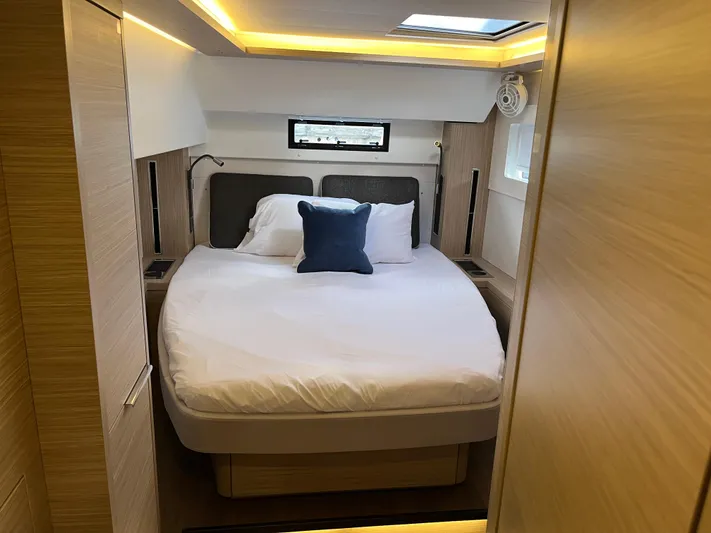  Yacht Photos Pics Luxurious bedroom interior of 2025 Lagoon 46 yacht with modern design and cozy bedding.
