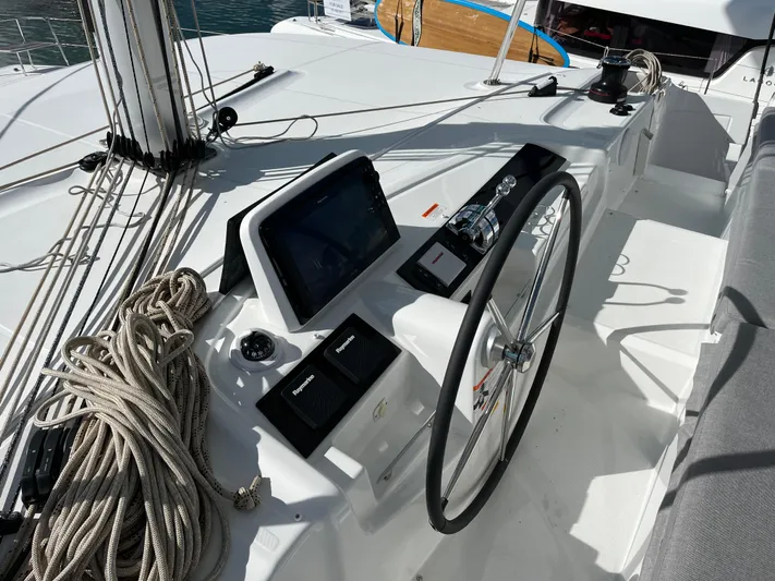  Yacht Photos Pics 2025 Lagoon 46 yacht helm with navigation equipment and steering wheel.