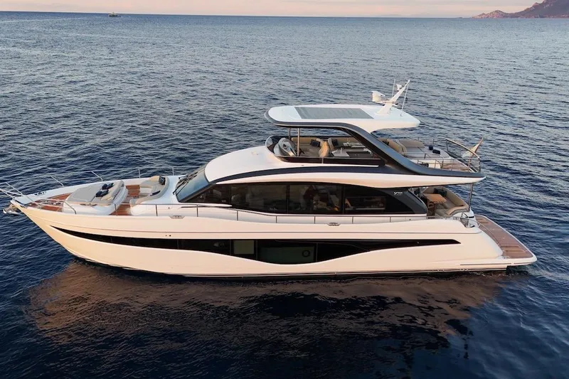  Yacht Photos Pics Luxury 2025 Princess Y72 yacht cruising on calm ocean waters at sunset.