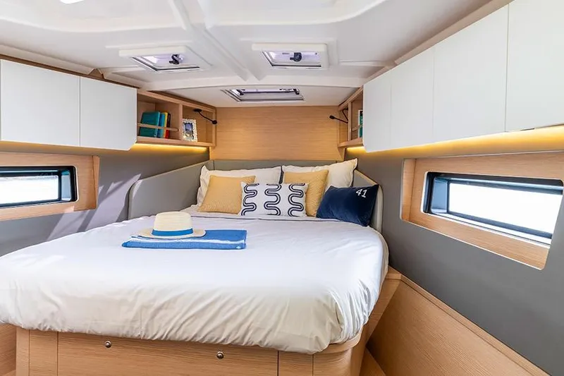  Yacht Photos Pics Luxurious cabin interior of 2026 Dufour 41 yacht with cozy bed and modern design.