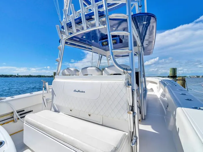  Yacht Photos Pics 2015 SeaHunter 45 boat with white seating and blue canopy on a sunny day.