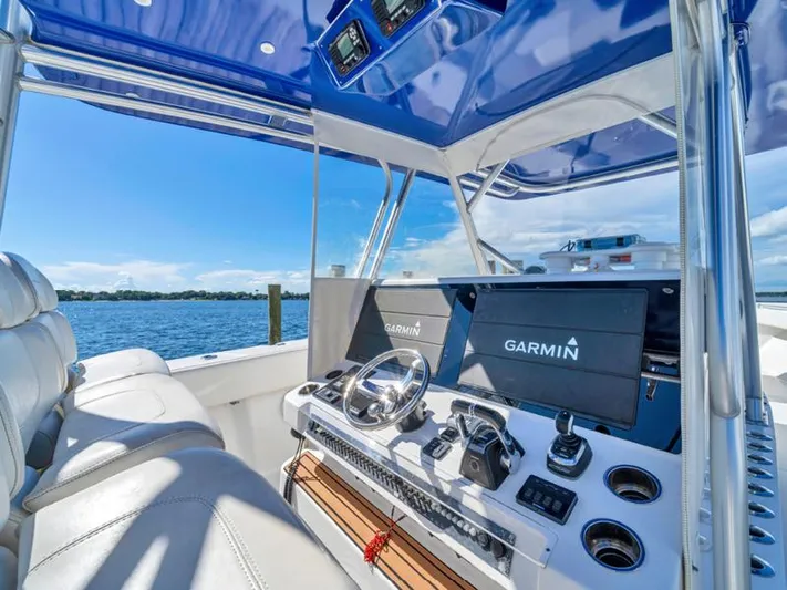  Yacht Photos Pics SeaHunter 45 2015 boat cockpit with Garmin navigation system and blue canopy.