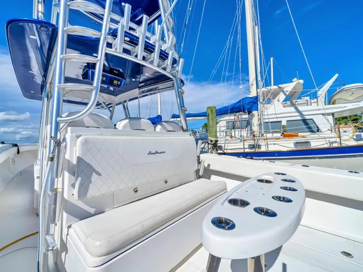  Yacht Photos Pics 2015 SeaHunter 45 boat with white seating and rod holders, docked at a marina.