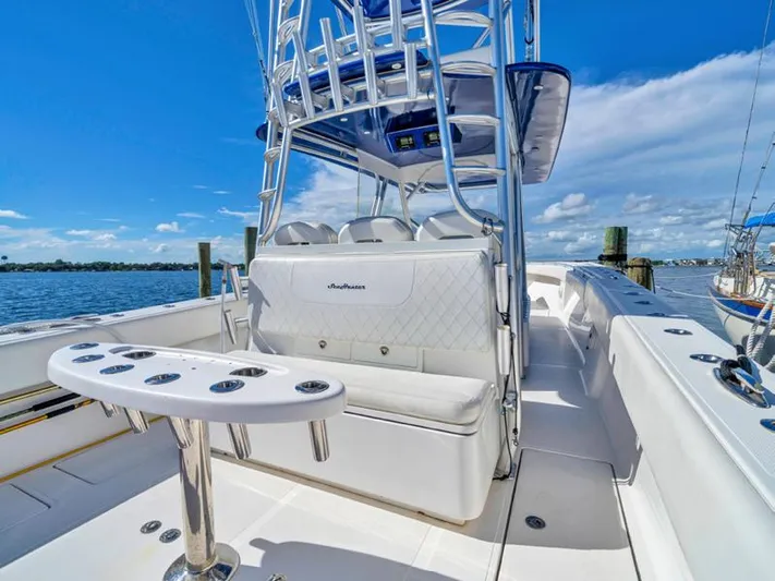  Yacht Photos Pics 2015 SeaHunter 45 boat with seating and rod holders, docked by the water.