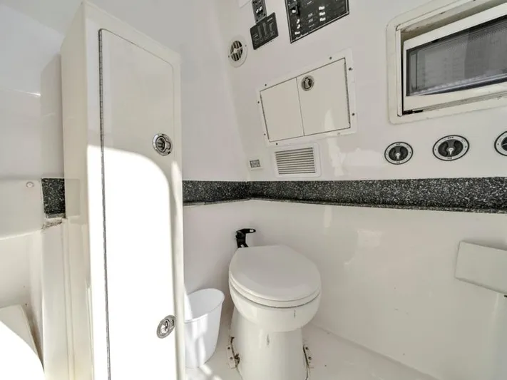  Yacht Photos Pics 2015 SeaHunter 45 boat bathroom with toilet and storage cabinets.