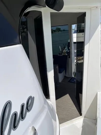  Yacht Photos Pics 2000 Carver 506 Motor Yacht entrance with partial interior view and water in the background.