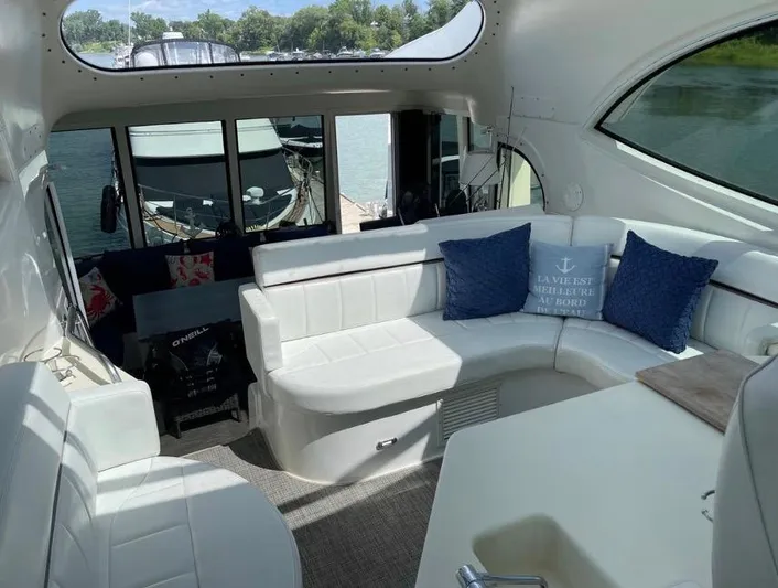  Yacht Photos Pics Interior of 2000 Carver 506 Motor Yacht with white seating and blue cushions.