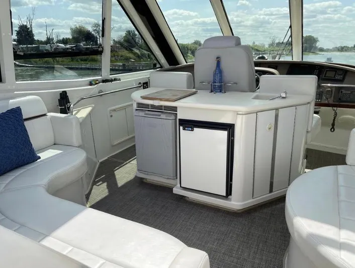  Yacht Photos Pics Interior of 2000 Carver 506 Motor Yacht with white seating and mini fridge.
