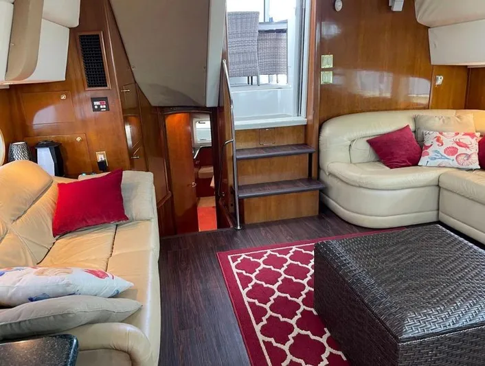  Yacht Photos Pics Interior of 2000 Carver 506 Motor Yacht with beige seating, red accents, and wooden finishes.