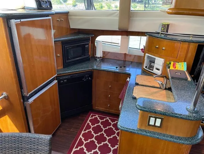  Yacht Photos Pics Interior of 2000 Carver 506 Motor Yacht kitchen with wood cabinetry and modern appliances.