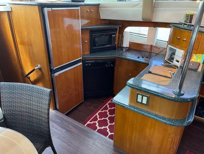  Yacht Photos Pics Luxurious kitchen interior of 2000 Carver 506 Motor Yacht with wood cabinetry and modern appliances.