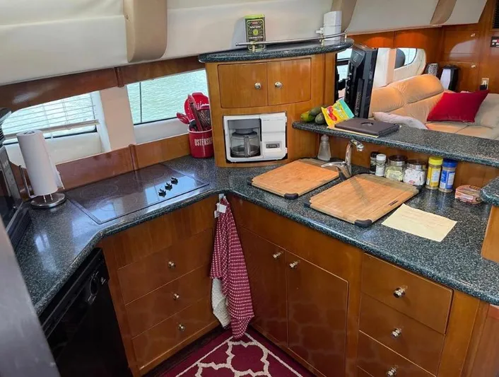  Yacht Photos Pics Interior kitchen of 2000 Carver 506 Motor Yacht with modern amenities and wooden cabinetry.