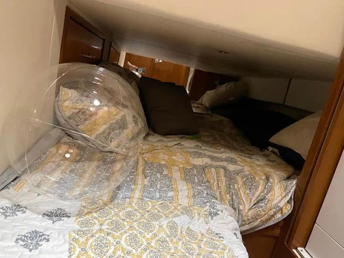  Yacht Photos Pics Cozy cabin interior of 2000 Carver 506 Motor Yacht with patterned bedding and pillows.